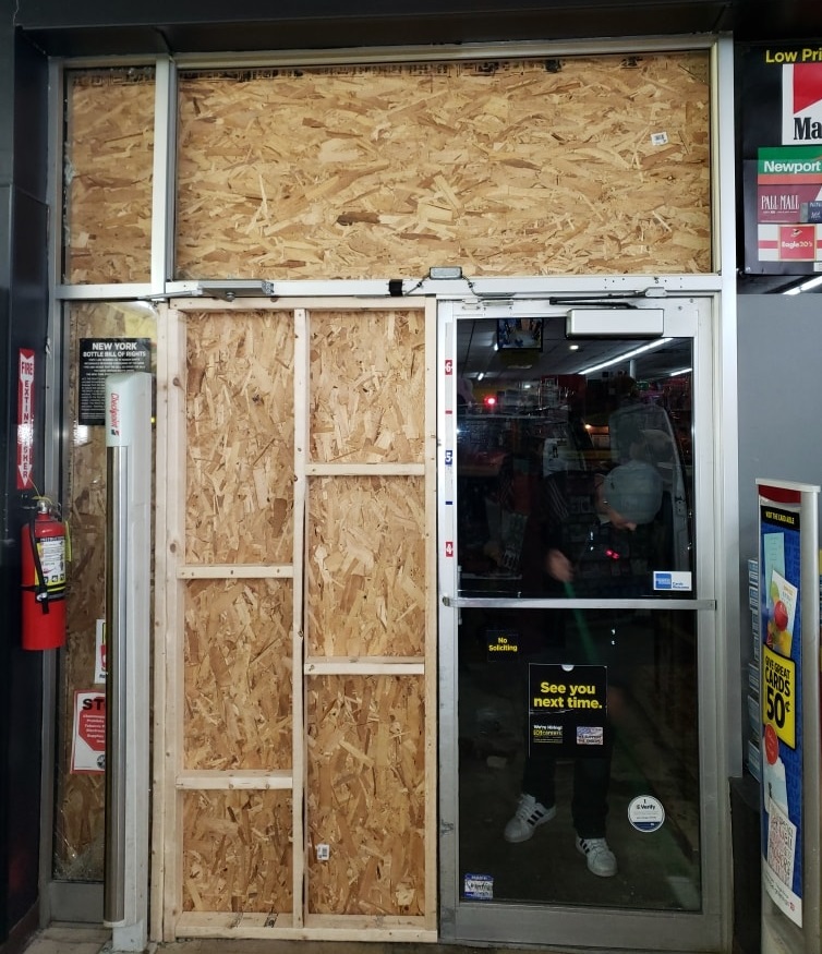 boarded-up-storefront-door-at-night