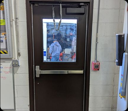 Steel commercial entry door with push bar in Cincinnati, OH, installed as part of A 24 Hour Door’s commercial door services.